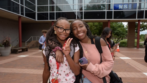 Students smiling at camera outside