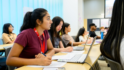 Girl sitting taking notes