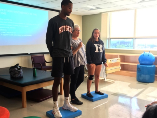 Students performing an exercise in front of class