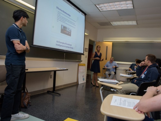 Students presenting in front of their pre-college class