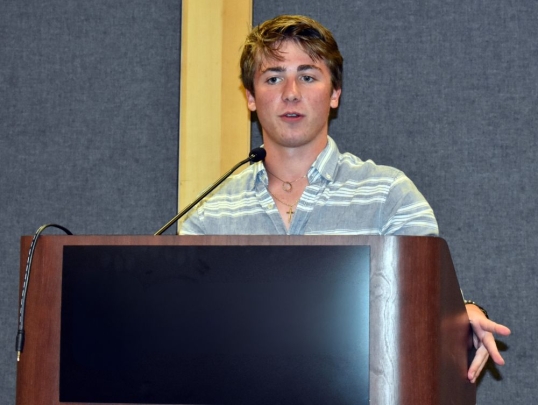 Student presenting at podium
