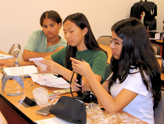 Students building a water bottle rocket