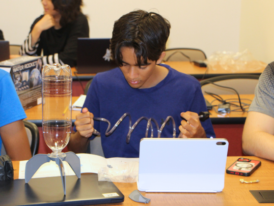 Student building a water bottle rocket