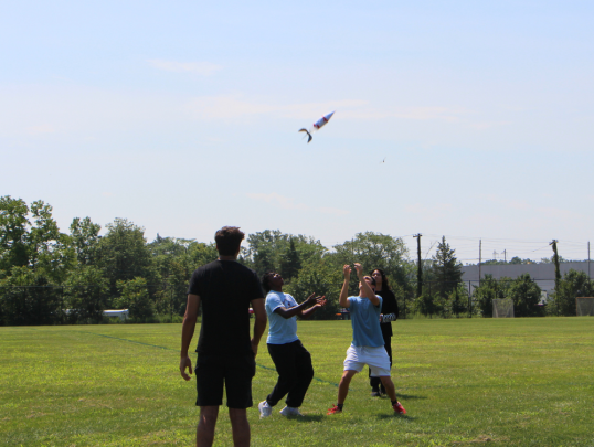 Students launching water bottle rockets outside