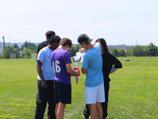 Students launching water bottle rockets outside