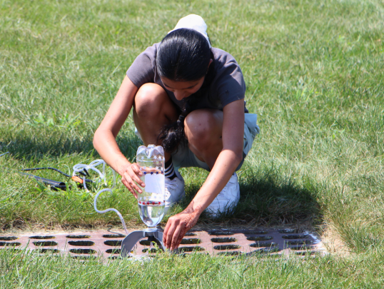 Students launching water bottle rockets outside