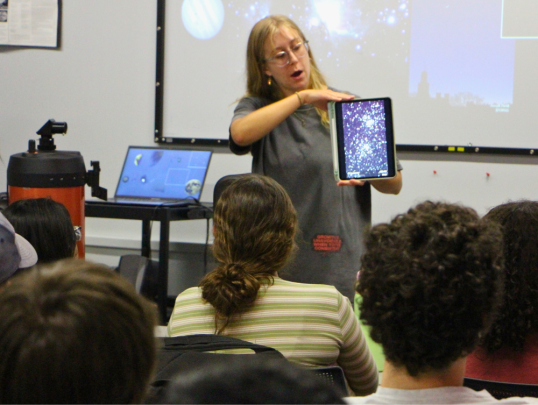 Student mentor lecturing on astronomy with images