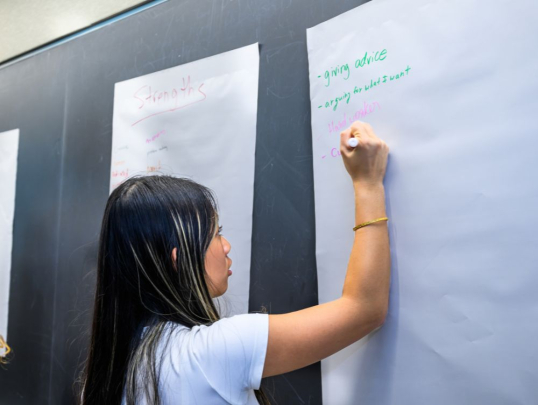 Student writing on the board