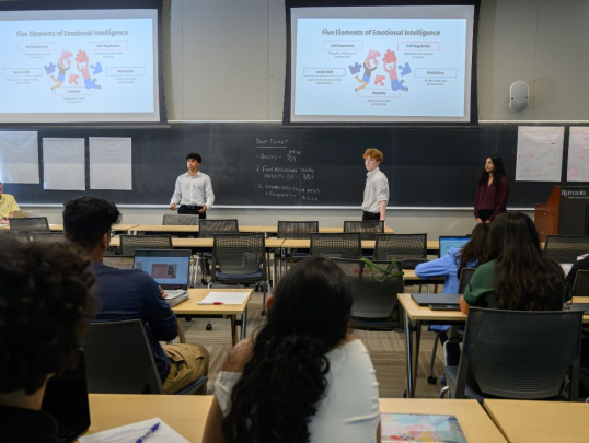 Students presenting in front of classmates
