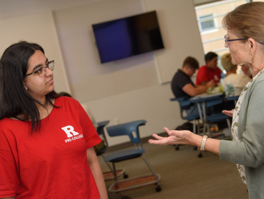 Student speaking to engineering instructor