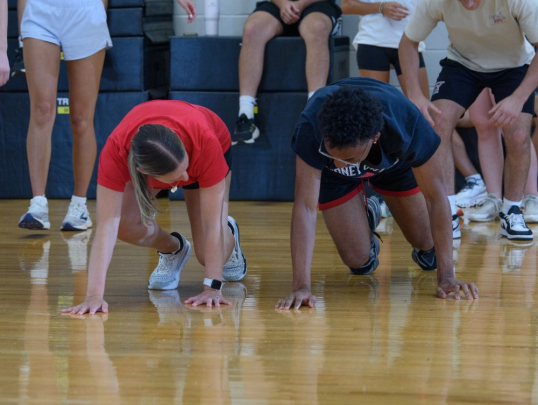 Students practicing physical therapy exercises with instructor