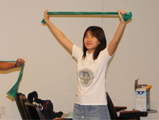 Student practicing physical therapy theraband exercises
